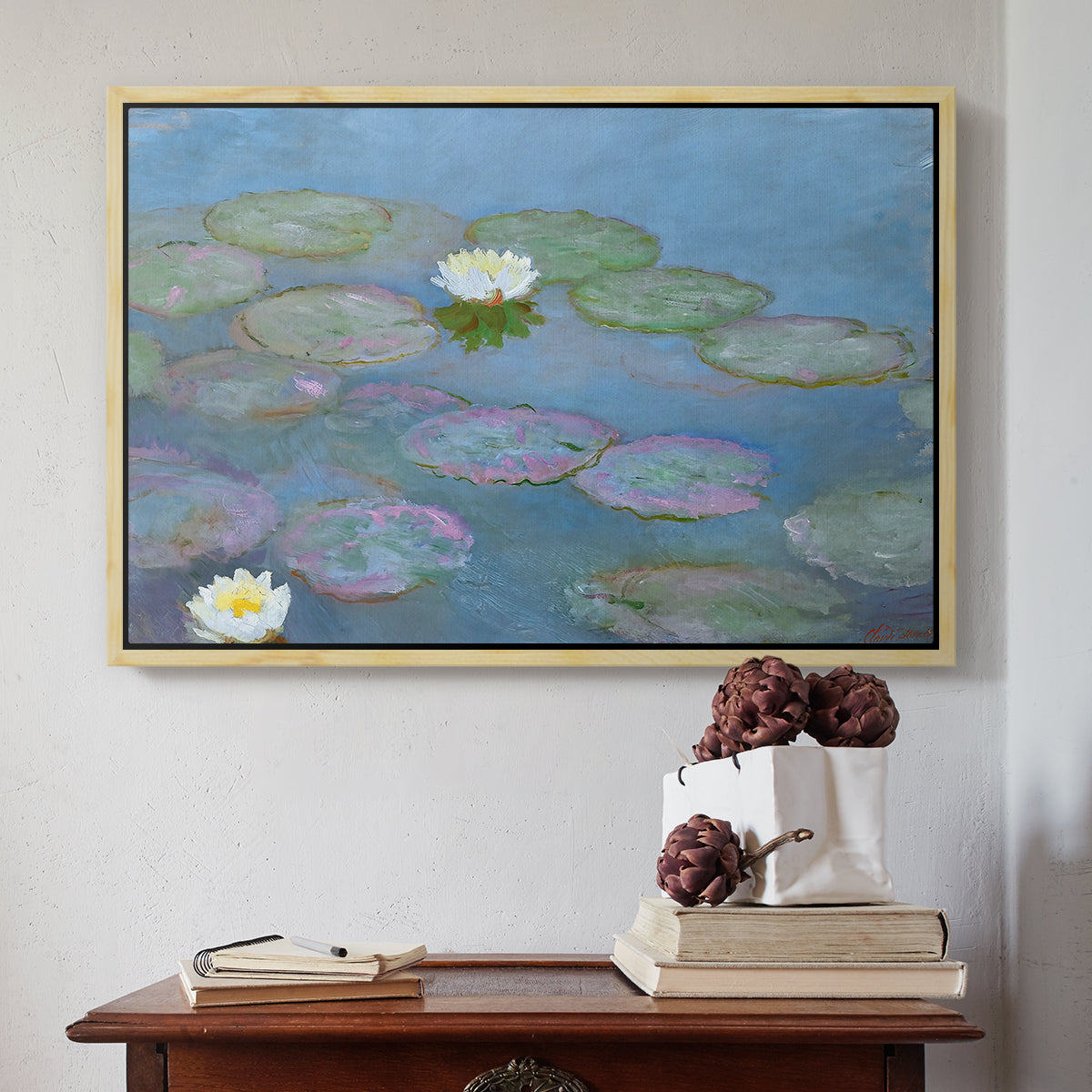 Natural wood floater framed canvas featuring Water Lilies (Nymphéas), 1897-1899 by Claude Monet above an entryway table in a minimalist foyer.