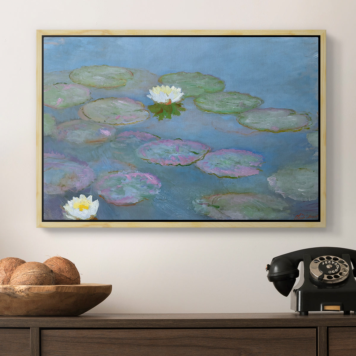 Water Lilies (Nymphéas), 1897-1899 by Claude Monet in a natural wood floater framed canvas displayed above a console table in a hallway, featuring a close-up of aquatic plants in still water.