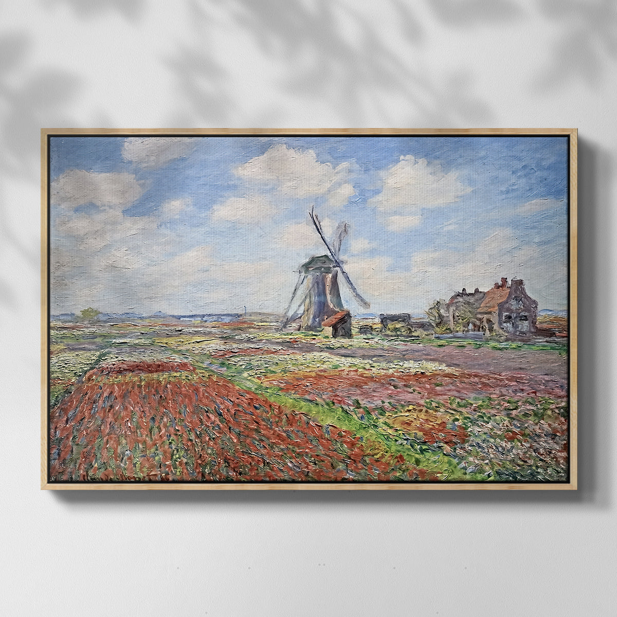 Front view of Tulip Fields with the Rijnsburg Windmill, 1886 by Claude Monet in a natural wood floater framed canvas.