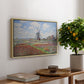 Tulip Fields with the Rijnsburg Windmill, 1886 by Claude Monet, presented in a natural wood floater framed canvas featuring colorful rows of tulip fields leading toward distant windmill, displayed above a hallway console table.