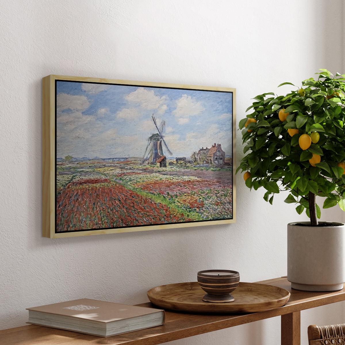 Tulip Fields with the Rijnsburg Windmill, 1886 by Claude Monet, presented in a natural wood floater framed canvas featuring colorful rows of tulip fields leading toward distant windmill, displayed above a hallway console table.