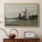 Natural wood floater framed canvas featuring a rustic scene with windmill and reflections in water, displayed above a cabinet in a soft-toned living room.