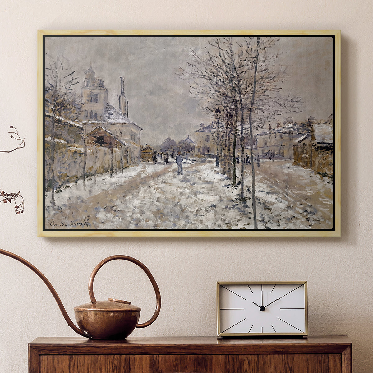 Natural wood floater framed canvas featuring a quiet boulevard blanketed in snow with distant figures, displayed above a cabinet in a soft-toned living room.