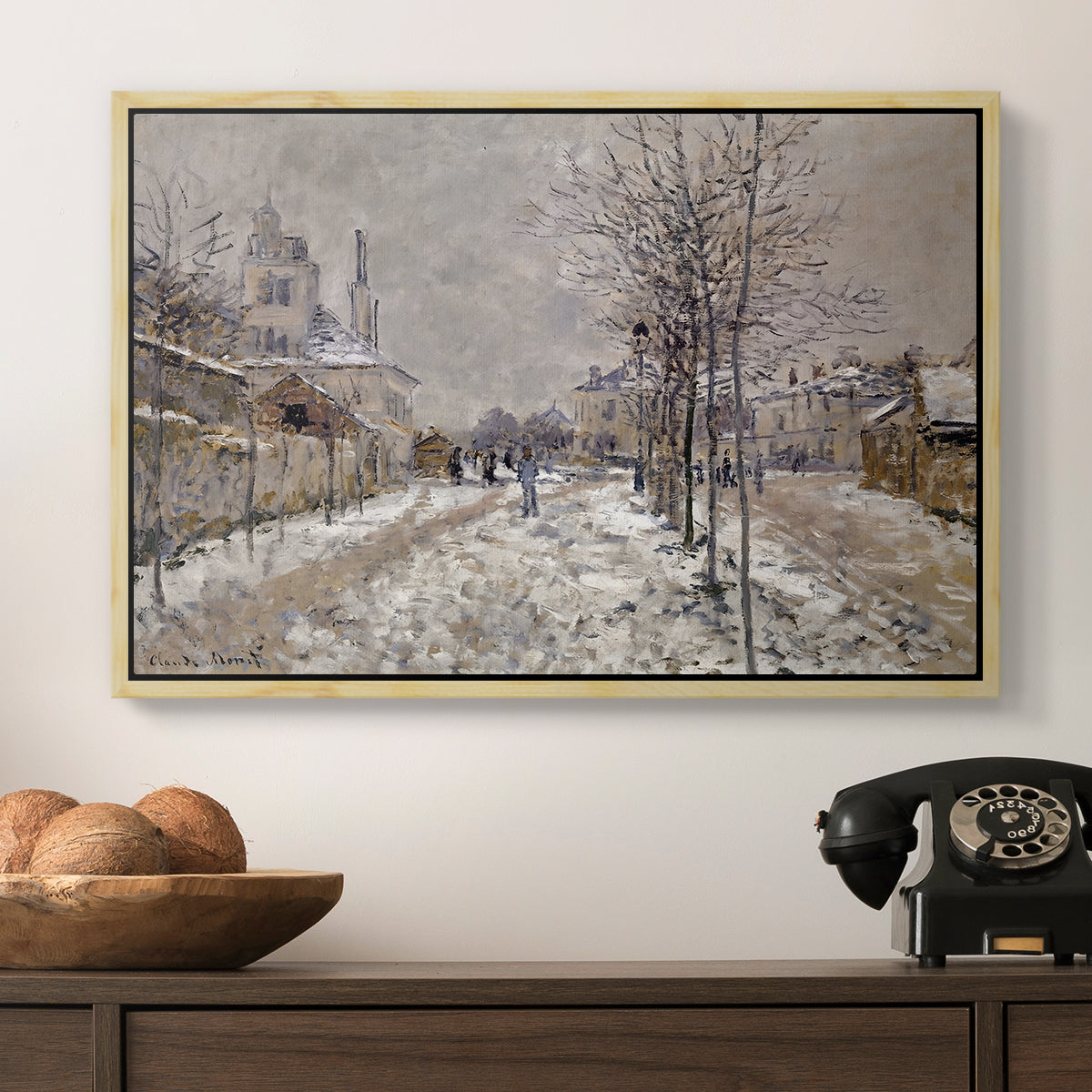 The Boulevard de Pontoise at Argenteuil, Snow Effect, 1875 by Claude Monet in a natural wood floater framed canvas displayed above a console table in a hallway, featuring an urban winter landscape with muted tones and soft light.