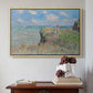 Natural wood floater framed canvas featuring The Cliff Walk at Pourville, 1882 by Claude Monet above an entryway table in a minimalist foyer.