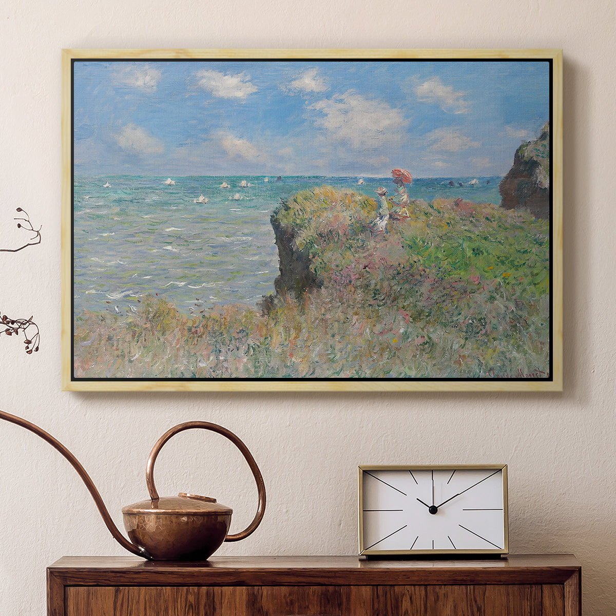 Natural wood floater framed canvas featuring a coastal cliff scene with grass, wind, and expansive sea view, displayed above a cabinet in a soft-toned living room.
