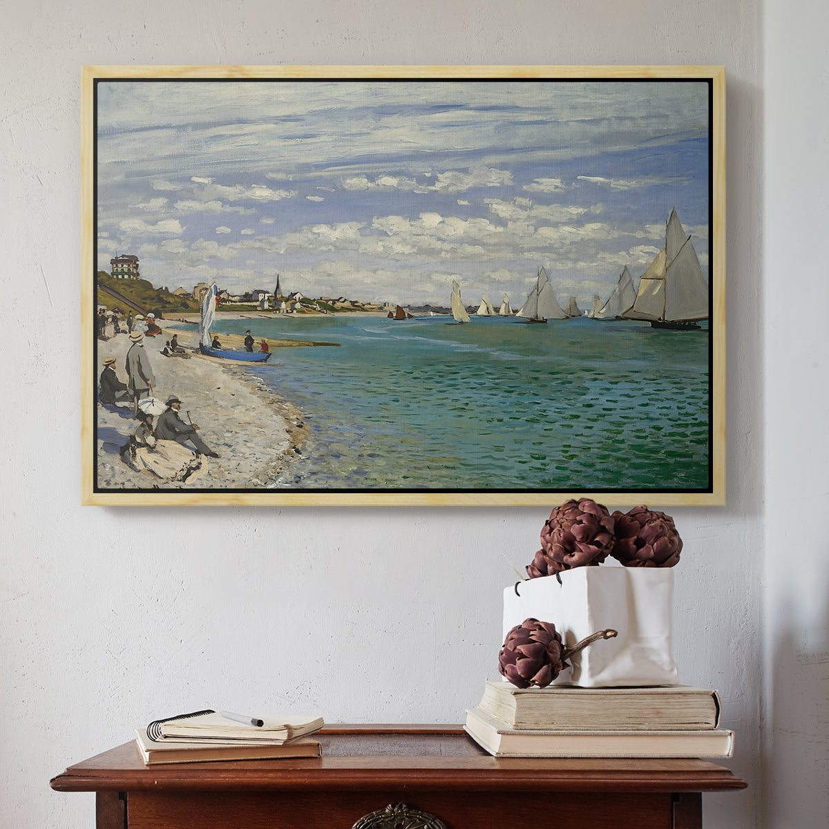 Natural wood floater framed canvas featuring Regatta at Sainte-Adresse, 1867 by Claude Monet above an entryway table in a minimalist foyer.