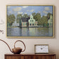 Natural wood floater framed canvas featuring a peaceful canal scene with houses mirrored in water, displayed above a cabinet in a soft-toned living room.