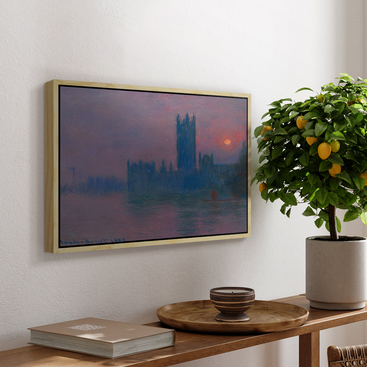 The Houses of Parliament, Sunset, 1903 by Claude Monet, presented in a natural wood floater framed canvas featuring a silhouette of Parliament buildings against glowing sunset across river, displayed above a hallway console table.