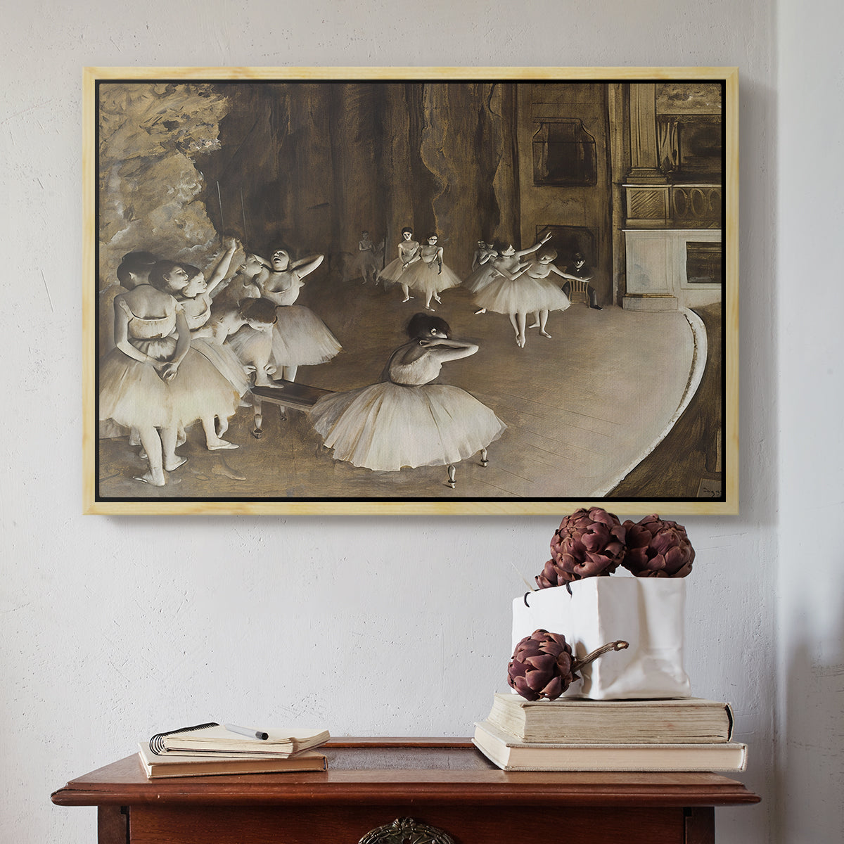 Natural wood floater framed canvas featuring The Rehearsal of the Ballet Onstage, 1874 by Edgar Degas above an entryway table in a minimalist foyer.