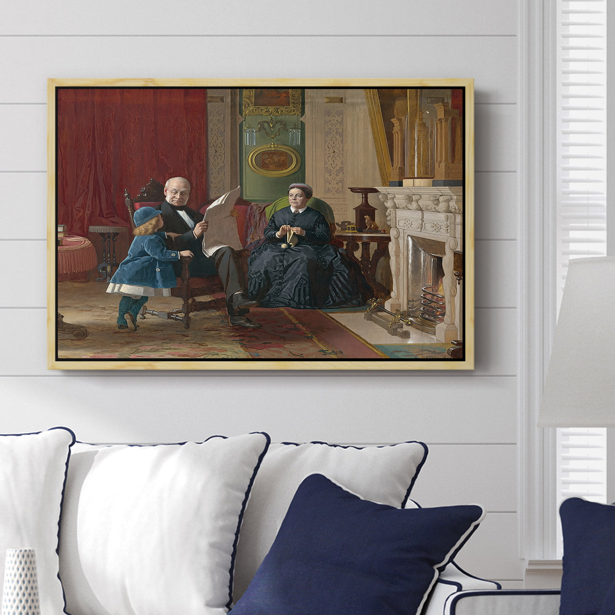 The Brown Family, 1869 by Eastman Johnson displayed above a sofa in a living room in a natural wood floater frame, featuring a domestic portrait of group gathered in modest home setting.