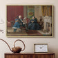 Natural wood floater framed canvas featuring an Americana scene with figures sitting and interacting indoors, displayed above a cabinet in a soft-toned living room.