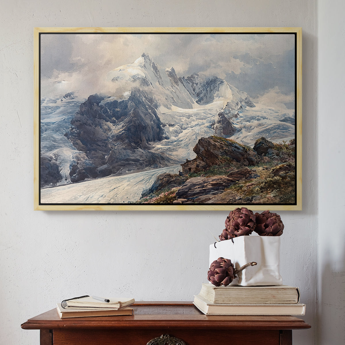 Natural wood floater framed canvas featuring The Grossglockner, 1880 by Edward Theodore Compton above an entryway table in a minimalist foyer.