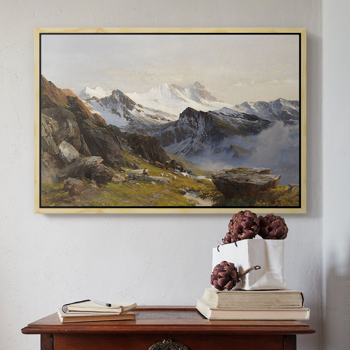 Natural wood floater framed canvas featuring The Großglockner from the Prager Hut, 1890 by Edward Theodore Compton above an entryway table in a minimalist foyer.