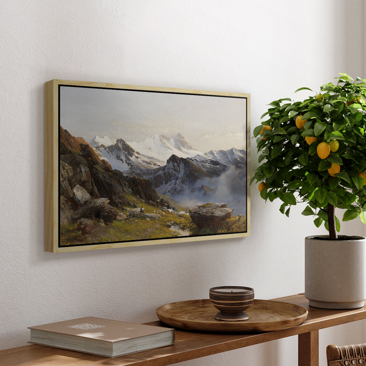 The Großglockner from the Prager Hut, 1890 by Edward Theodore Compton, presented in a natural wood floater framed canvas featuring a view of Großglockner peak from alpine hut overlooking valley, displayed above a hallway console table.