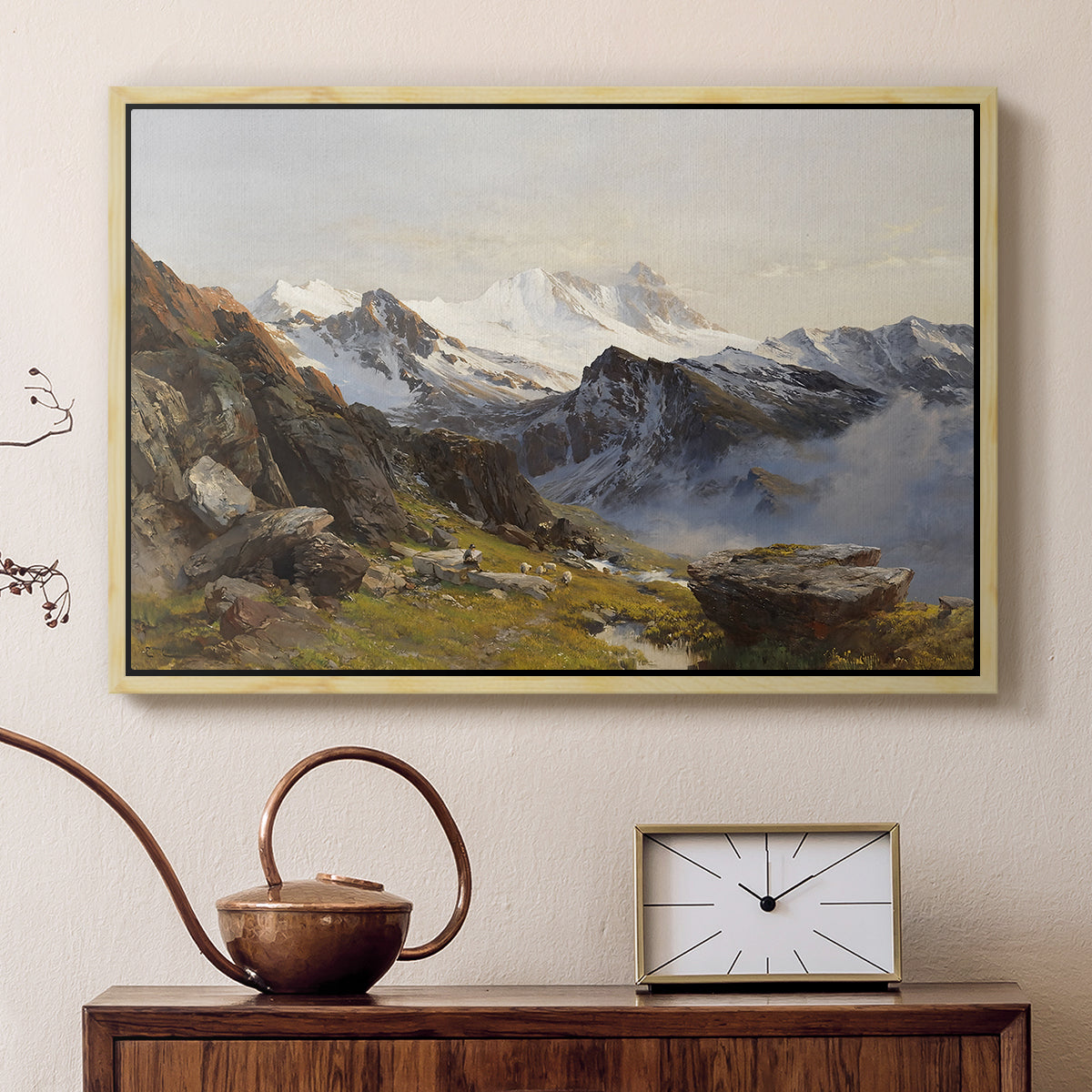 Natural wood floater framed canvas featuring an alpine vista with towering peak and foreground terrain, displayed above a cabinet in a soft-toned living room.
