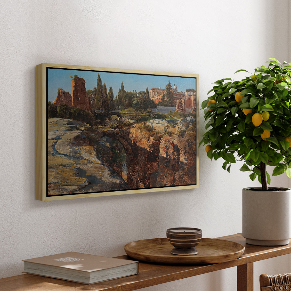 Palatine in Rome, c. 1921 by Edward Theodore Compton, presented in a natural wood floater framed canvas featuring historic Roman ruins and buildings set within warm landscape, displayed above a hallway console table.
