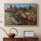 Natural wood floater framed canvas featuring a cityscape with classical ruins and surrounding terrain, displayed above a cabinet in a soft-toned living room.