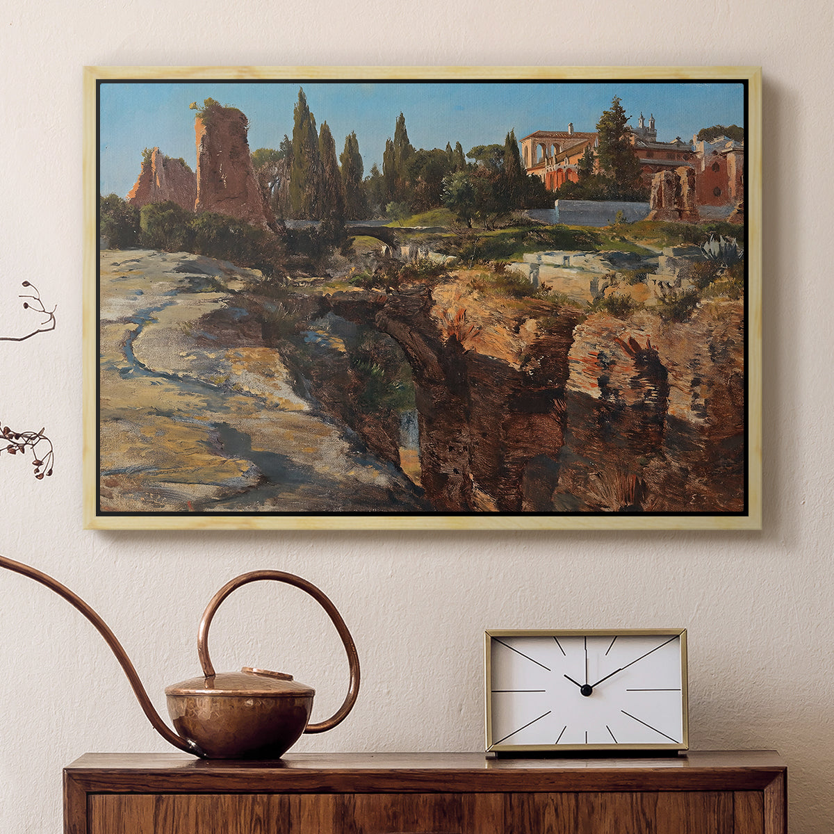 Natural wood floater framed canvas featuring a cityscape with classical ruins and surrounding terrain, displayed above a cabinet in a soft-toned living room.