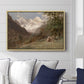 Landscape in the Caucasus, c. 1921 by Edward Theodore Compton displayed above a sofa in a living room in a natural wood floater frame, featuring an expansive view of Caucasus mountains under open sky.