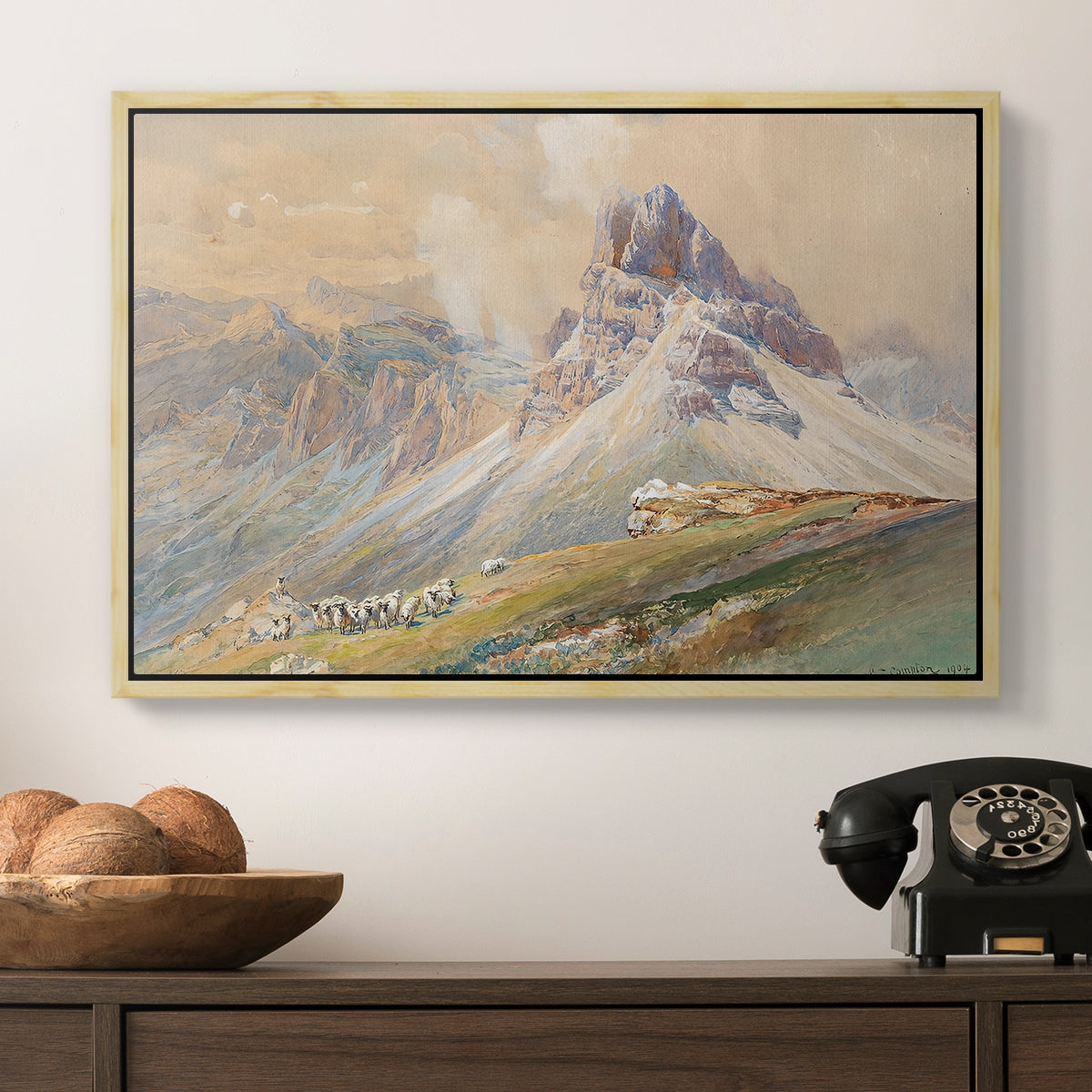 From the Dolomites, 1904 by Edward Theodore Compton in a natural wood floater framed canvas displayed above a console table in a hallway, featuring a realistic mountain view with strong geological forms.