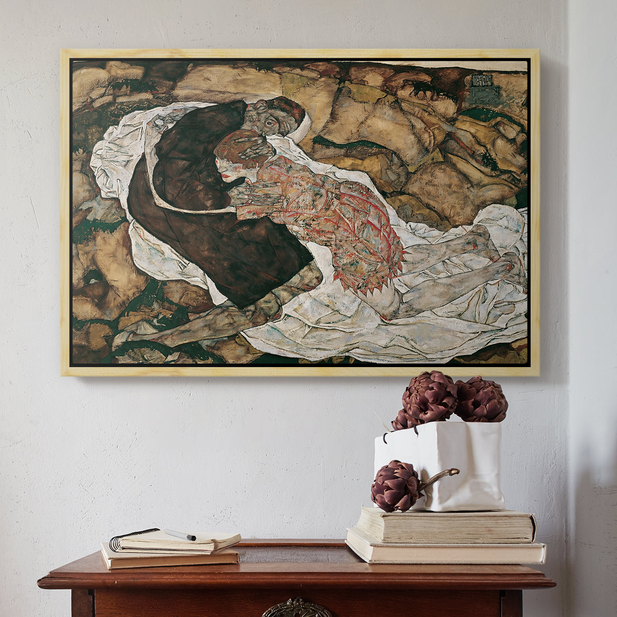 Natural wood floater framed canvas featuring Death and the Maiden, 1915 by Egon Schiele above an entryway table in a minimalist foyer.