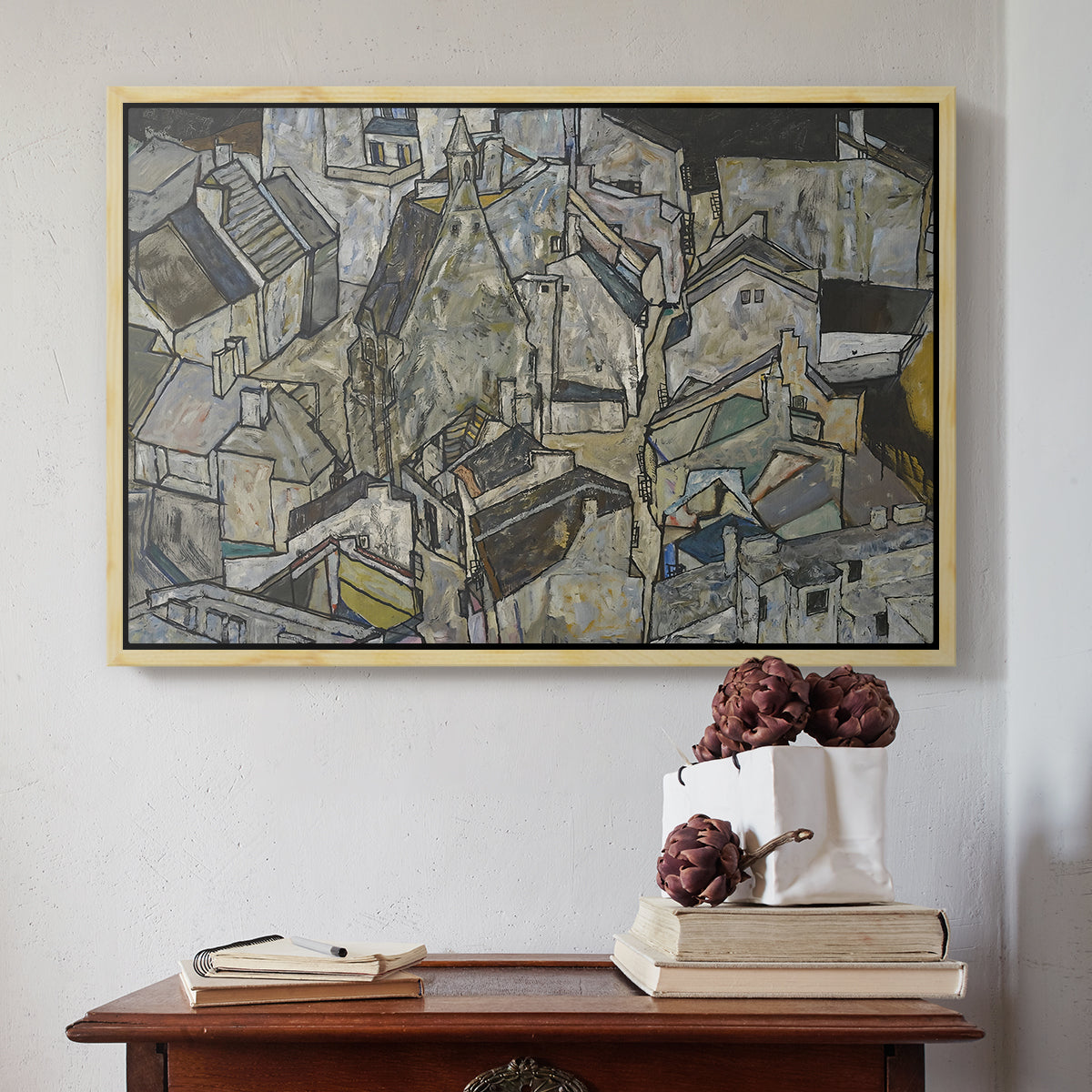 Natural wood floater framed canvas featuring Mödling II, 1918 by Egon Schiele above an entryway table in a minimalist foyer.