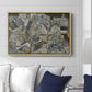 Mödling II, 1918 by Egon Schiele displayed above a sofa in a living room in a natural wood floater frame, featuring an expressionist cityscape with tightly packed buildings and bold lines.