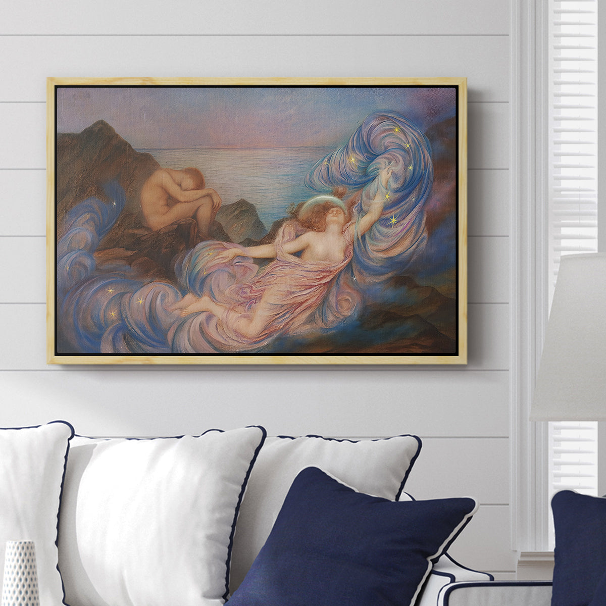 Twilight, 1914 by Evelyn De Morgan displayed above a sofa in a living room in a natural wood floater frame, featuring an allegorical figure resting in atmospheric dusk setting.