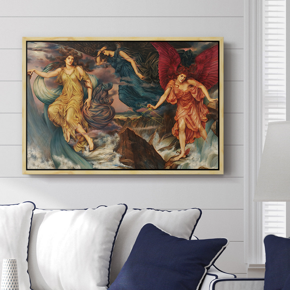 The Storm Spirits, 1900 by Evelyn De Morgan displayed above a sofa in a living room in a natural wood floater frame, featuring a dramatic allegory of spirits moving within turbulent sky.
