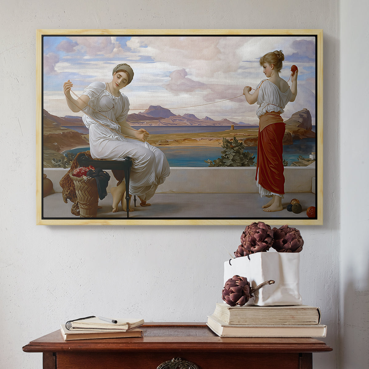 Natural wood floater framed canvas featuring Winding the Skein, c. 1878 by Frederic Leighton above an entryway table in a minimalist foyer.
