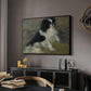 Tama, the Japanese Dog, c. 1876 by Pierre-Auguste Renoir in a black floater framed canvas featuring a close-up of a small dog in motion surrounded by rippling water, displayed above a desk in a dark home office interior.