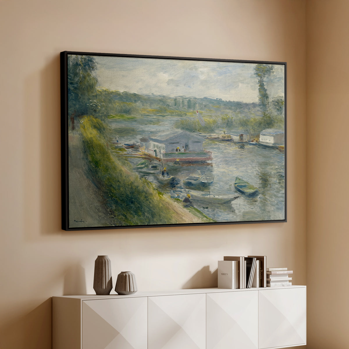 Black floater framed canvas of Wash-House Boat at Bas-Meudon, c. 1874 by Pierre-Auguste Renoir, featuring a riverside scene with moored boat used for washing clothes above a console cabinet in a minimalist entryway.