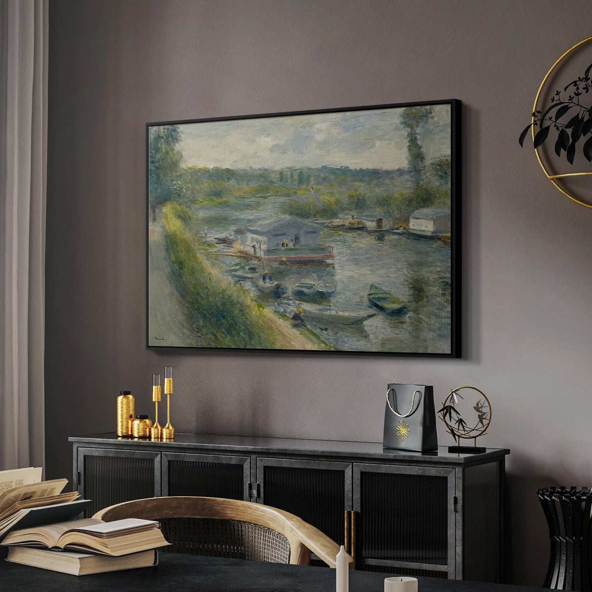 Wash-House Boat at Bas-Meudon, c. 1874 by Pierre-Auguste Renoir in a black floater framed canvas featuring an impressionist depiction of working boat along calm waterway, displayed above a desk in a dark home office interior.