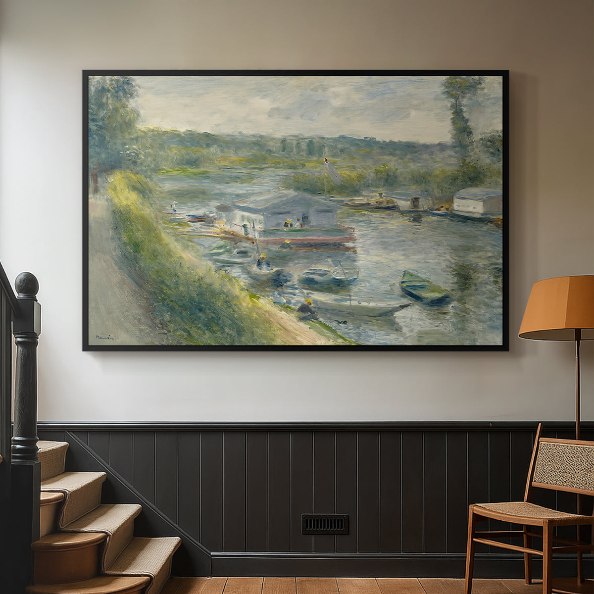 Black floater framed canvas featuring an everyday life scene with boat and figures along river edge, displayed in a hallway near a staircase.
