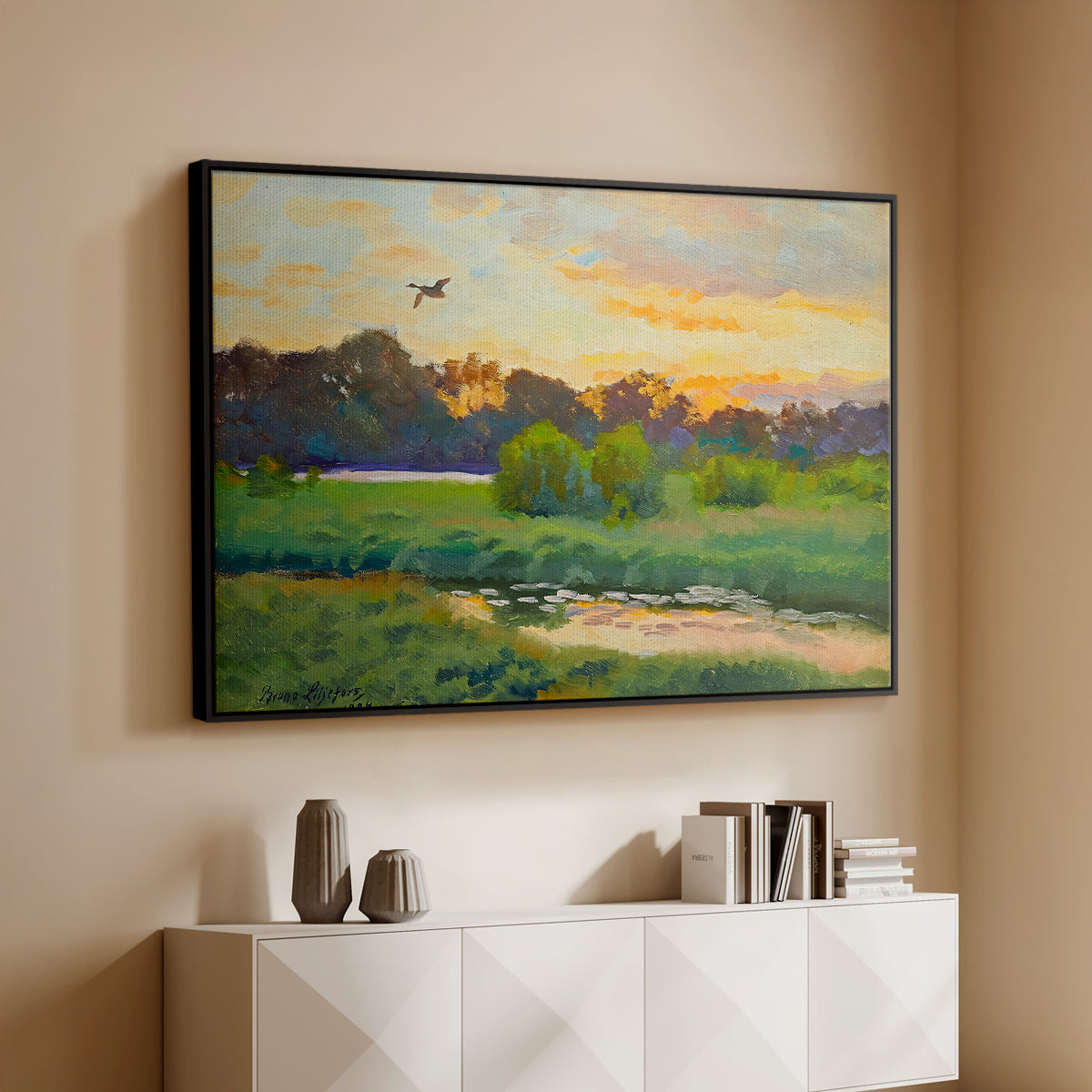 Black floater framed canvas of Flying Duck at Sunset, 1924 by Bruno Liljefors, featuring a lone duck soaring over a glowing marshland above a console cabinet in a minimalist entryway.