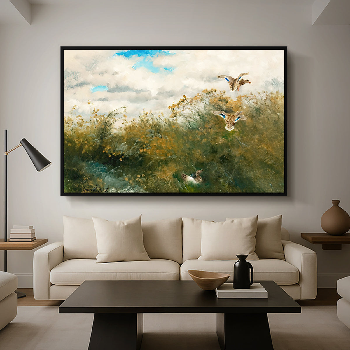 Wild Ducks (Grasänder), 1890 by Bruno Liljefors as a black floater framed canvas featuring ducks moving through grassy wetland near water's edge, displayed above a sofa in a modern living room.