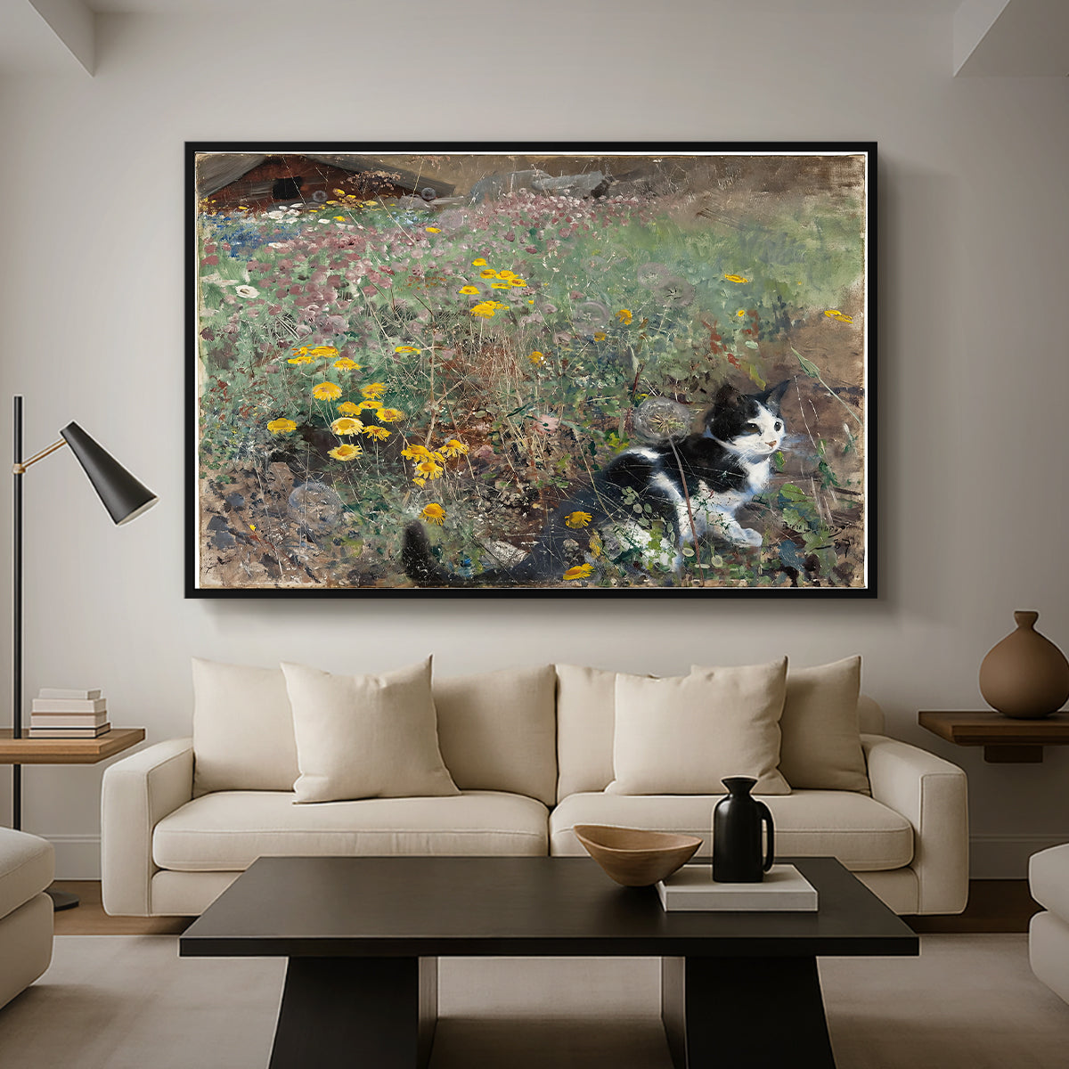 Cat on a Flowery Meadow, 1887 by Bruno Liljefors as a black floater framed canvas featuring a cat crouching in a meadow filled with wildflowers and greenery, displayed above a sofa in a modern living room.