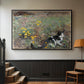 Black floater framed canvas featuring a naturalistic depiction of cat in blooming countryside setting, displayed in a hallway near a staircase.
