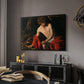 Saint John the Baptist in the Wilderness, c. 1603-1604 by Caravaggio in a black floater framed canvas featuring a biblical youth seated outdoors with symbolic staff and minimal landscape, displayed above a desk in a dark home office interior.