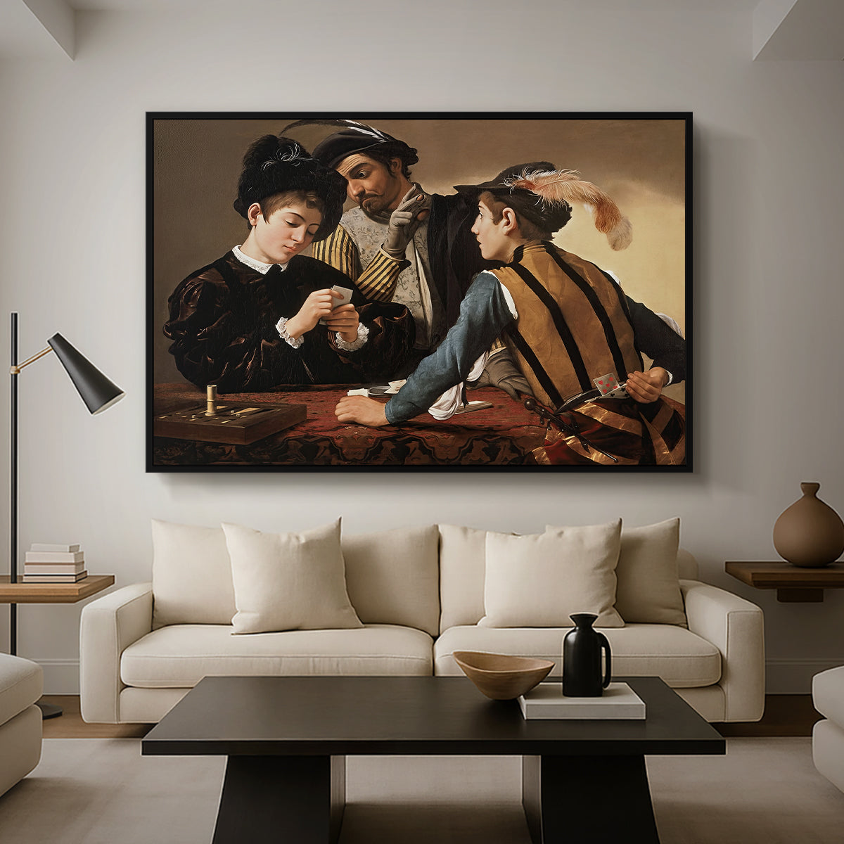 The Cardsharps, c. 1594 by Caravaggio as a black floater framed canvas featuring two men cheating at cards while a third figure secretly observes behind them, displayed above a sofa in a modern living room.
