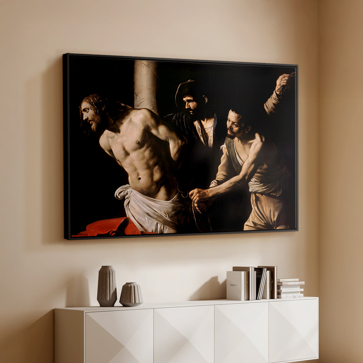 Black floater framed canvas of The Flagellation of Christ at the Column (Rouen Version), 1606 by Caravaggio, featuring a dramatic religious scene of Christ enduring flagellation in dark interior above a console cabinet in a minimalist entryway.