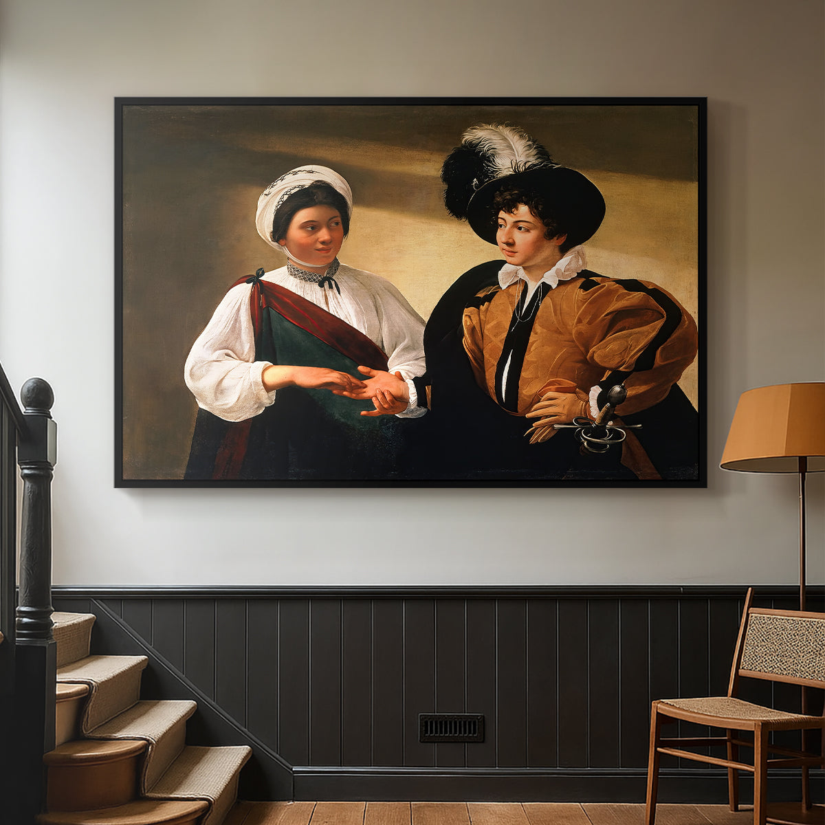 Black floater framed canvas featuring two figures engaged in fortune telling with hidden deception, displayed in a hallway near a staircase.