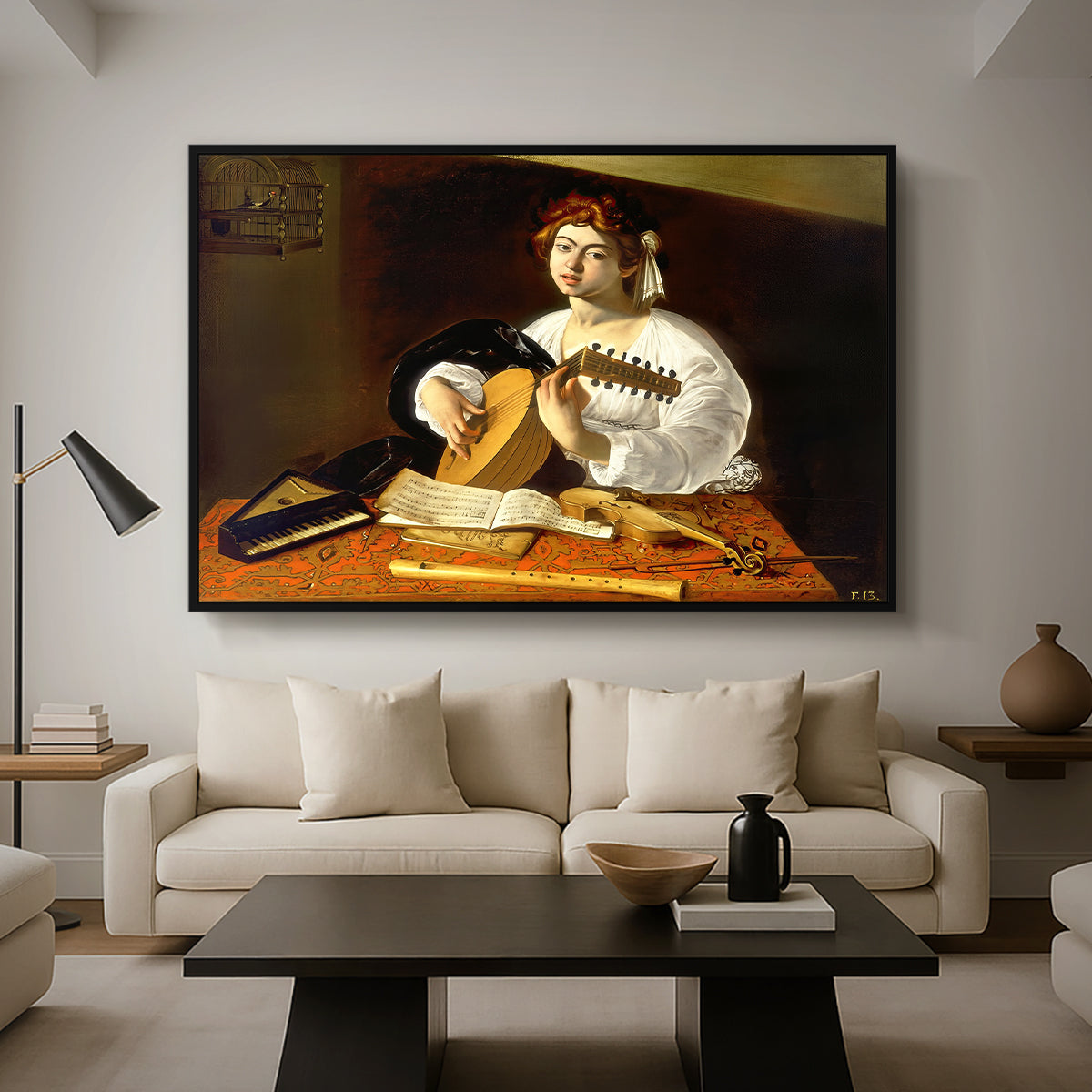 The Lute Player (Wildenstein Version), c. 1596 by Caravaggio as a black floater framed canvas featuring a young man playing lute surrounded by sheet music and still life objects, displayed above a sofa in a modern living room.