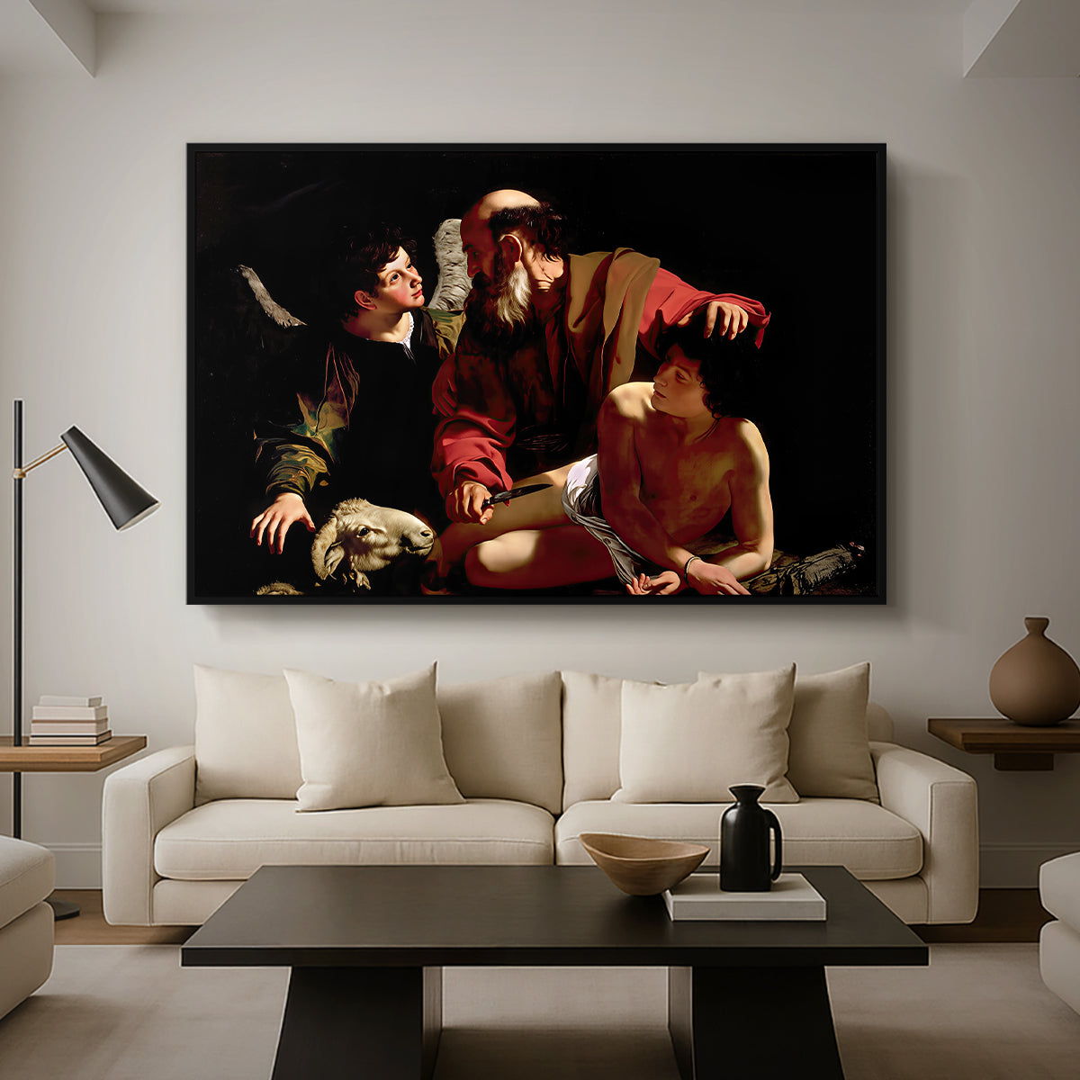The Sacrifice of Isaac (Uffizi Version), c. 1603 by Caravaggio as a black floater framed canvas featuring Abraham holding Isaac while angel intervenes to stop the sacrifice, displayed above a sofa in a modern living room.