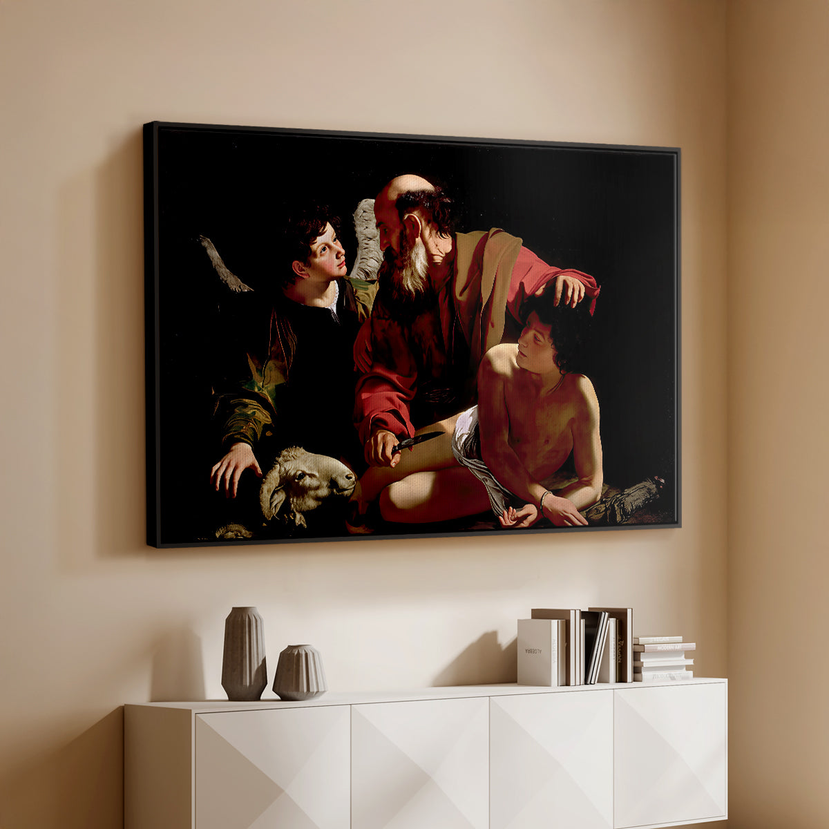 Black floater framed canvas of The Sacrifice of Isaac (Uffizi Version), c. 1603 by Caravaggio, featuring a biblical scene of father about to sacrifice son as angel restrains him above a console cabinet in a minimalist entryway.