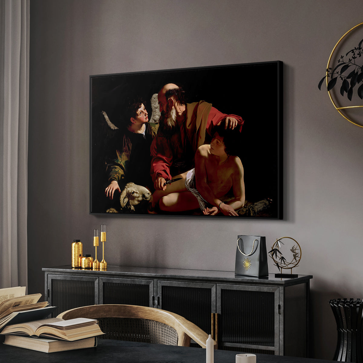 The Sacrifice of Isaac (Uffizi Version), c. 1603 by Caravaggio in a black floater framed canvas featuring a dramatic moment of divine intervention during sacrifice of Isaac, displayed above a desk in a dark home office interior.
