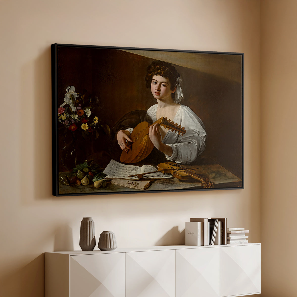 Black floater framed canvas of The Lute Player (Hermitage Version), c. 1596 by Caravaggio, featuring a portrait of lute player surrounded by still life arrangement above a console cabinet in a minimalist entryway.