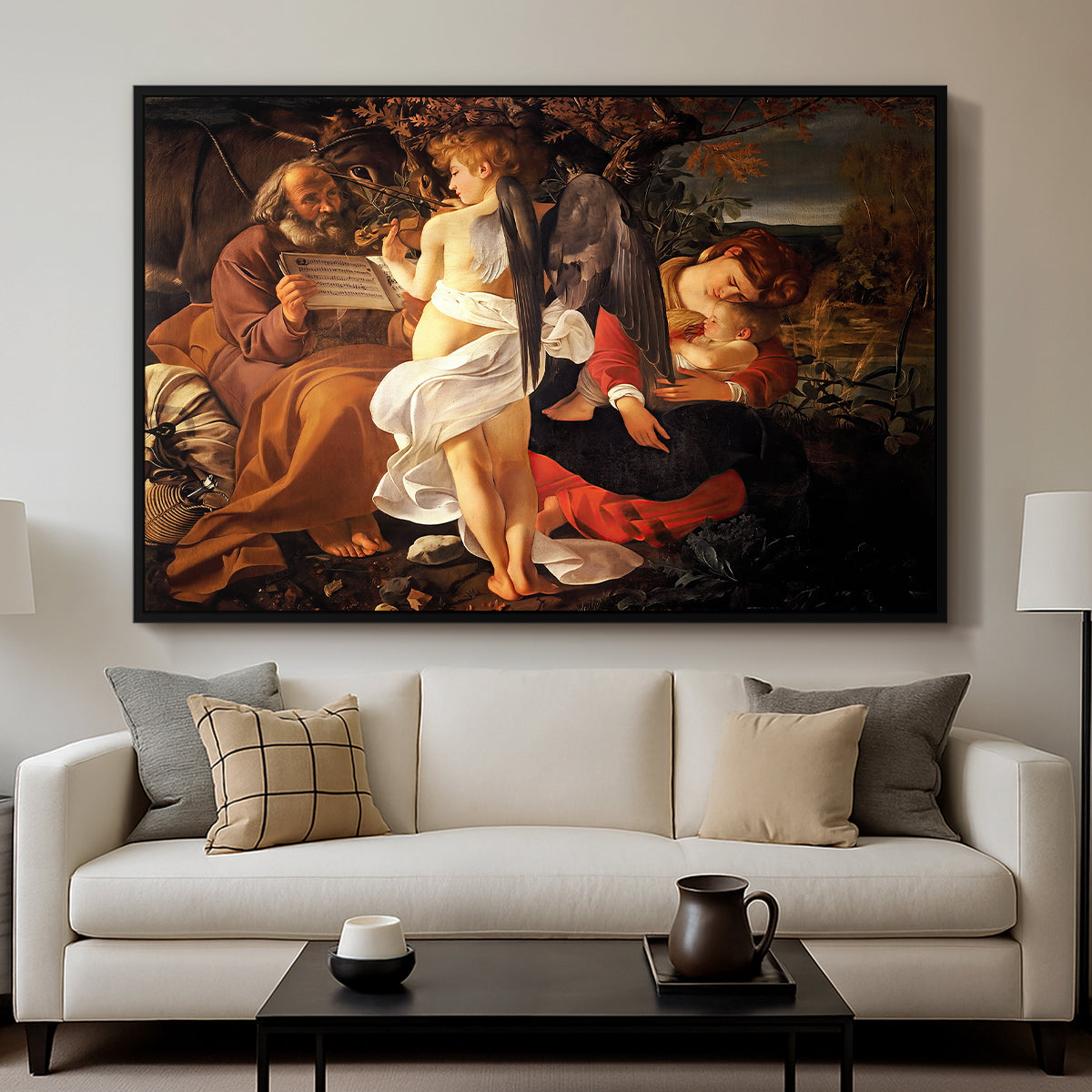 Rest on the Flight into Egypt, c. 1597 by Caravaggio displayed in a black floater framed canvas above a sofa in a clean living room.