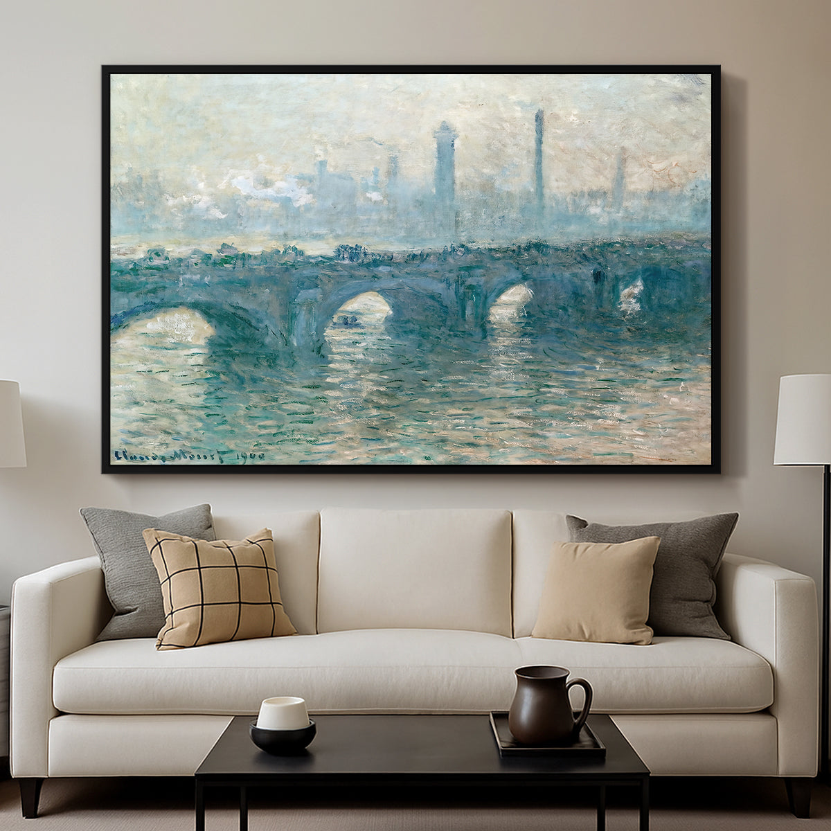 Waterloo Bridge, Gray Weather, 1900 by Claude Monet displayed in a black floater framed canvas above a sofa in a clean living room.